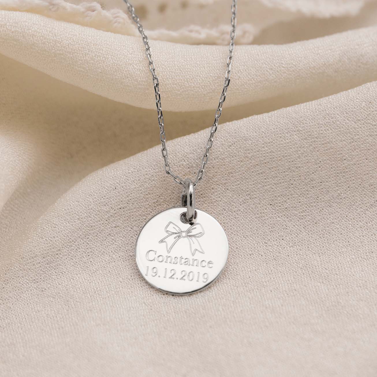 Personalised sterling silver baptism medal with bo