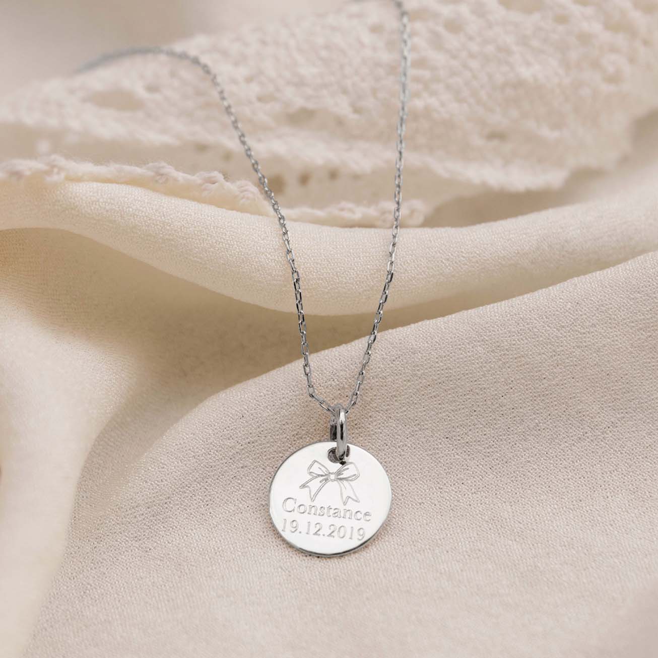 Personalised sterling silver baptism medal with bo